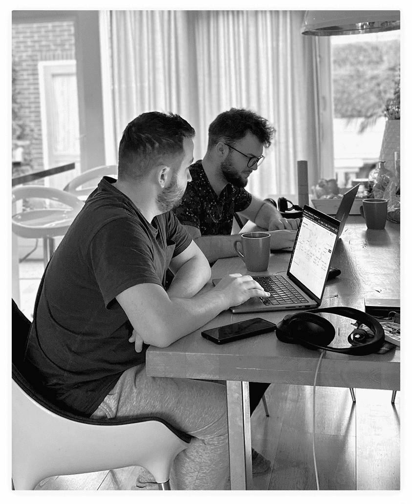 The BinarCode team collaborating around a laptop